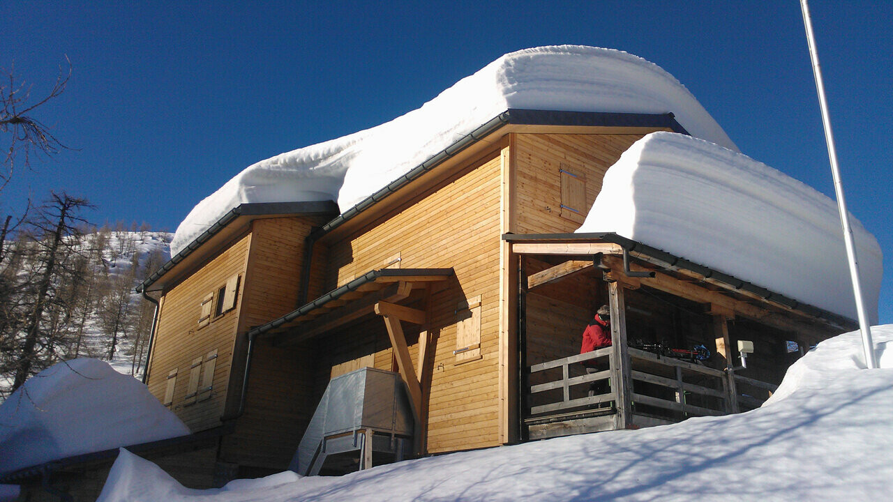 Capanna Buffalora hut with several centimetres of snow on the roof. 