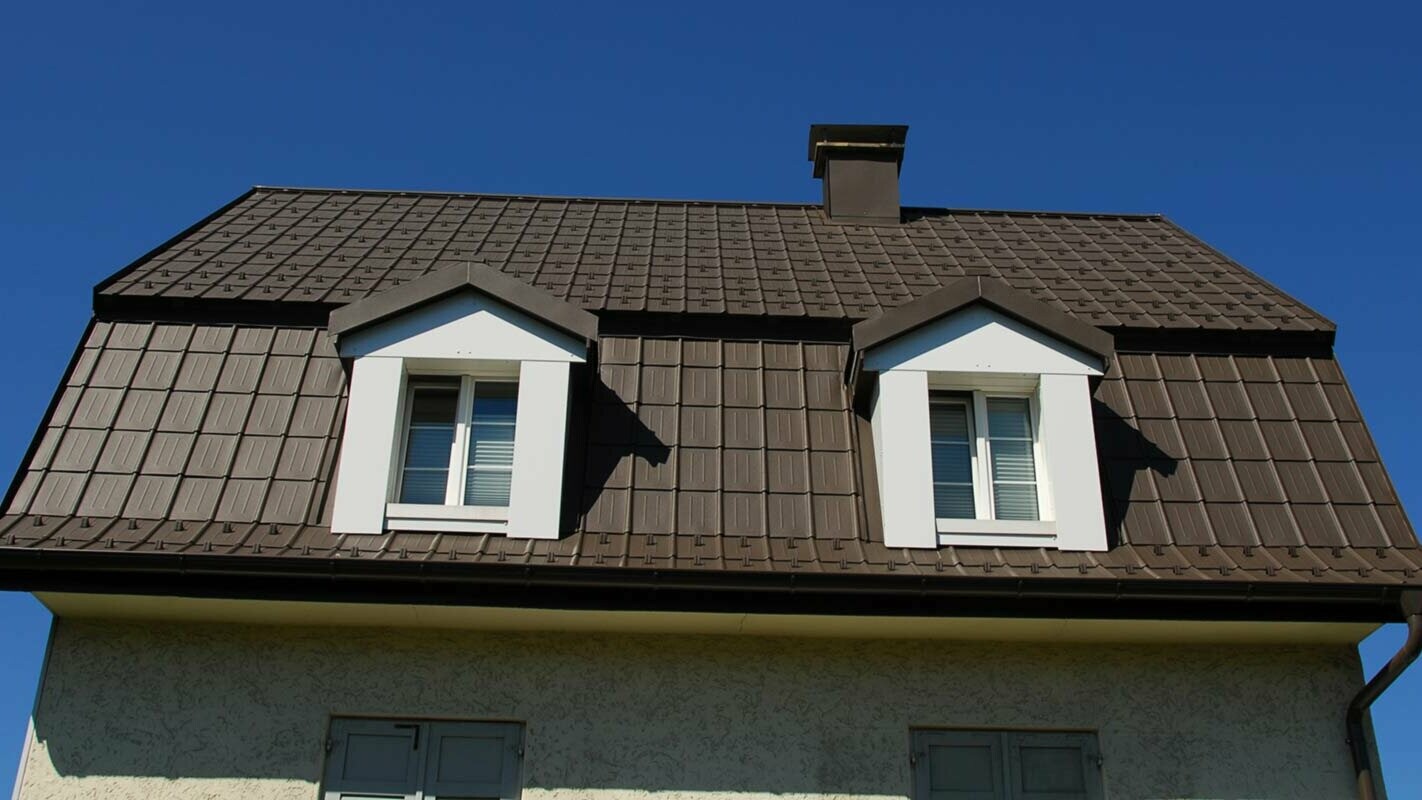 Mansard roof renovated with PREFA roof tiles including dormer cladding