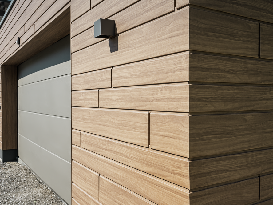 Close-up of a garage clad with PREFA Sidings in wood look. Walnut brown was chosen as the colour.