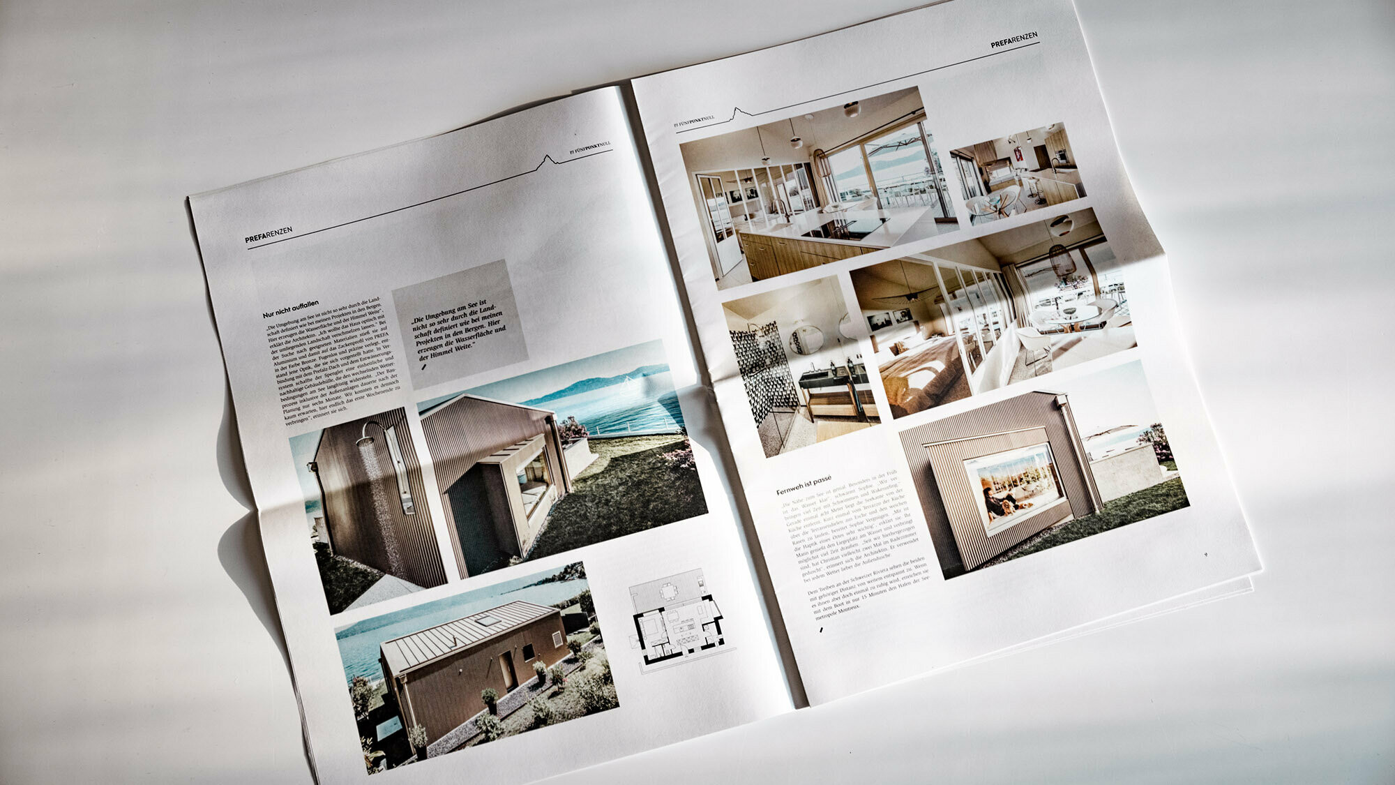 Frontal view of a tilted double page with text and architecture photos.