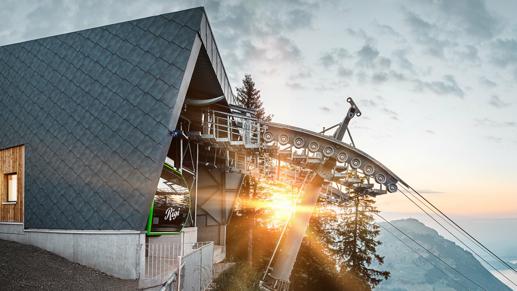 Cable car with PREFA roof and façade in Switzerland at sunset.