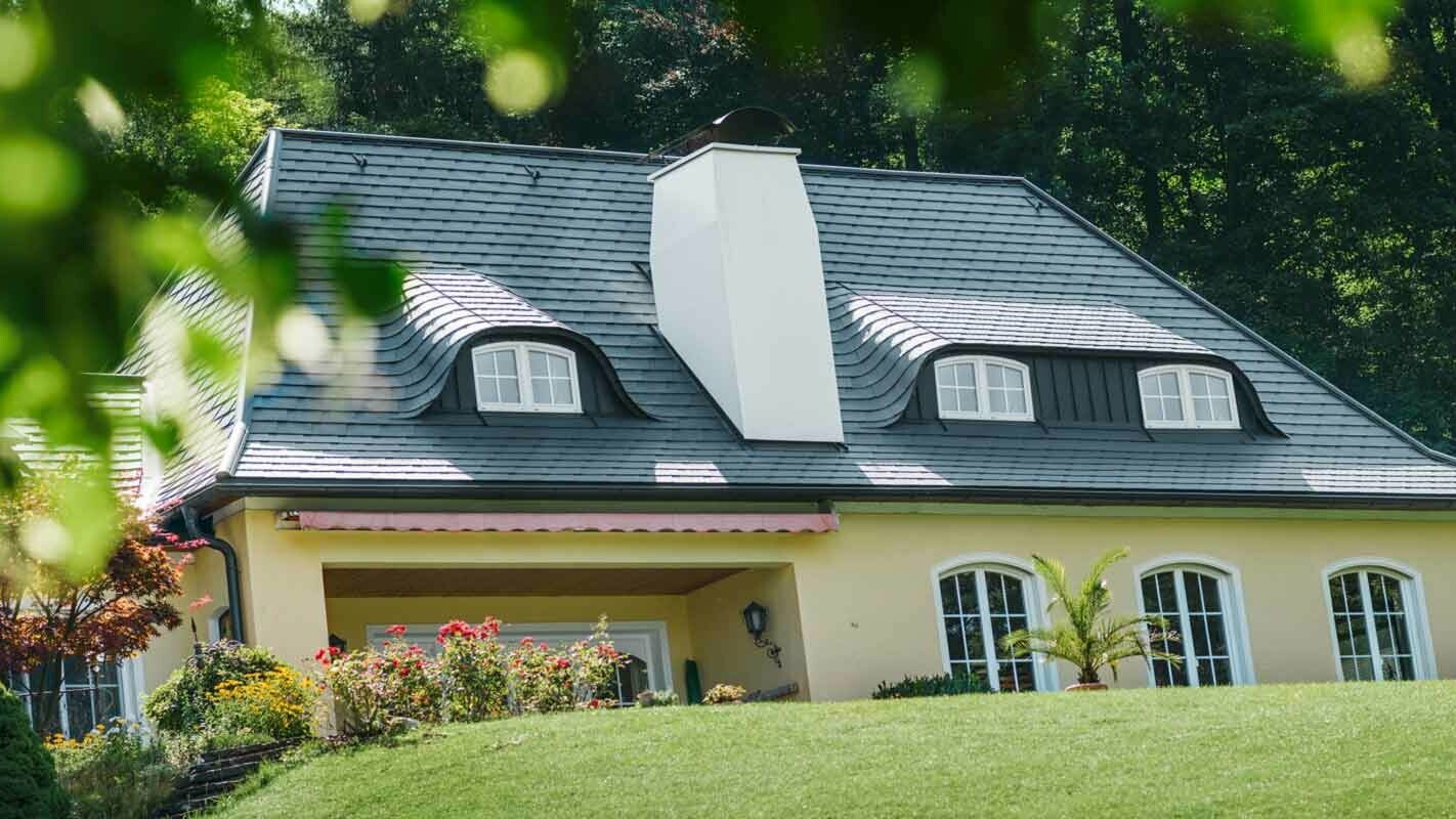 House roof and eyebrow dormer renovated with PREFA shingles and large chimney