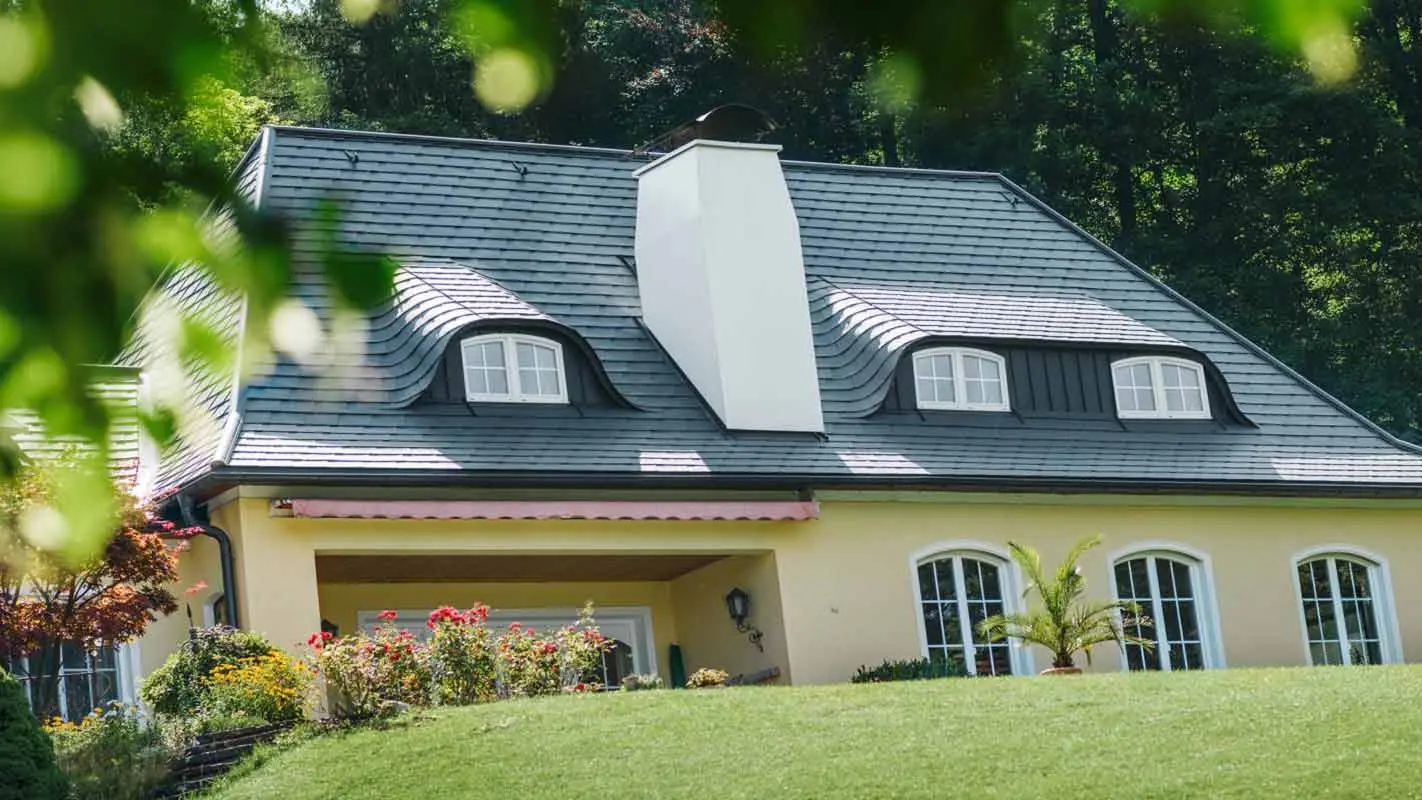 House roof and eyebrow dormer renovated with PREFA shingles and large chimney