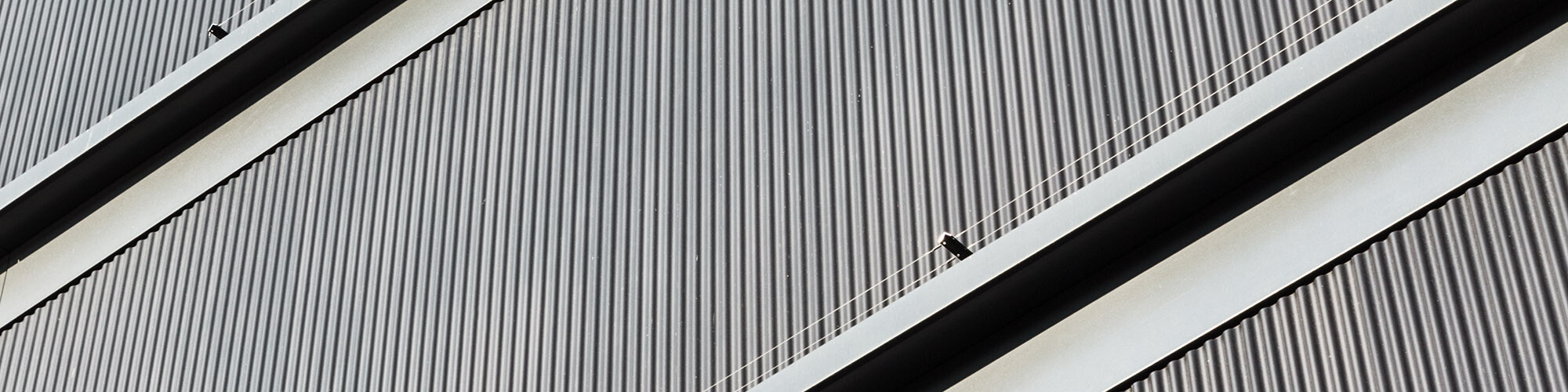 A close-up of the linear, black grey aluminium façade that is extremely similar to the pre-greyed silver fir that was used for the project.