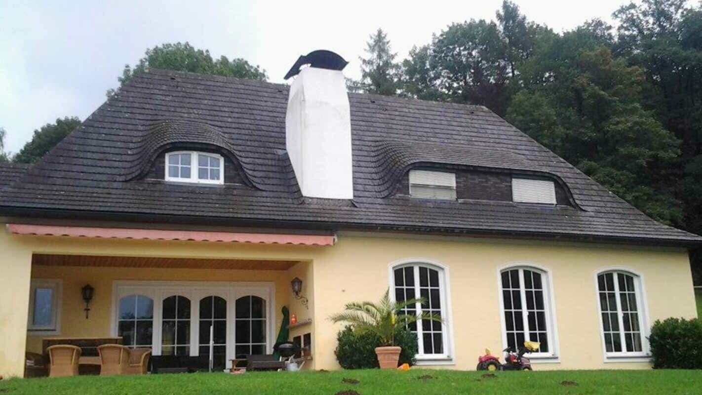 House roof and eyebrow dormer before renovation with PREFA shingles and large chimney