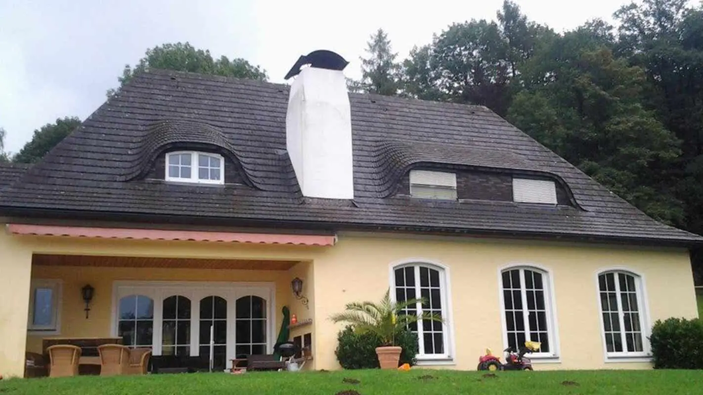 House roof and eyebrow dormer before renovation with PREFA shingles and large chimney