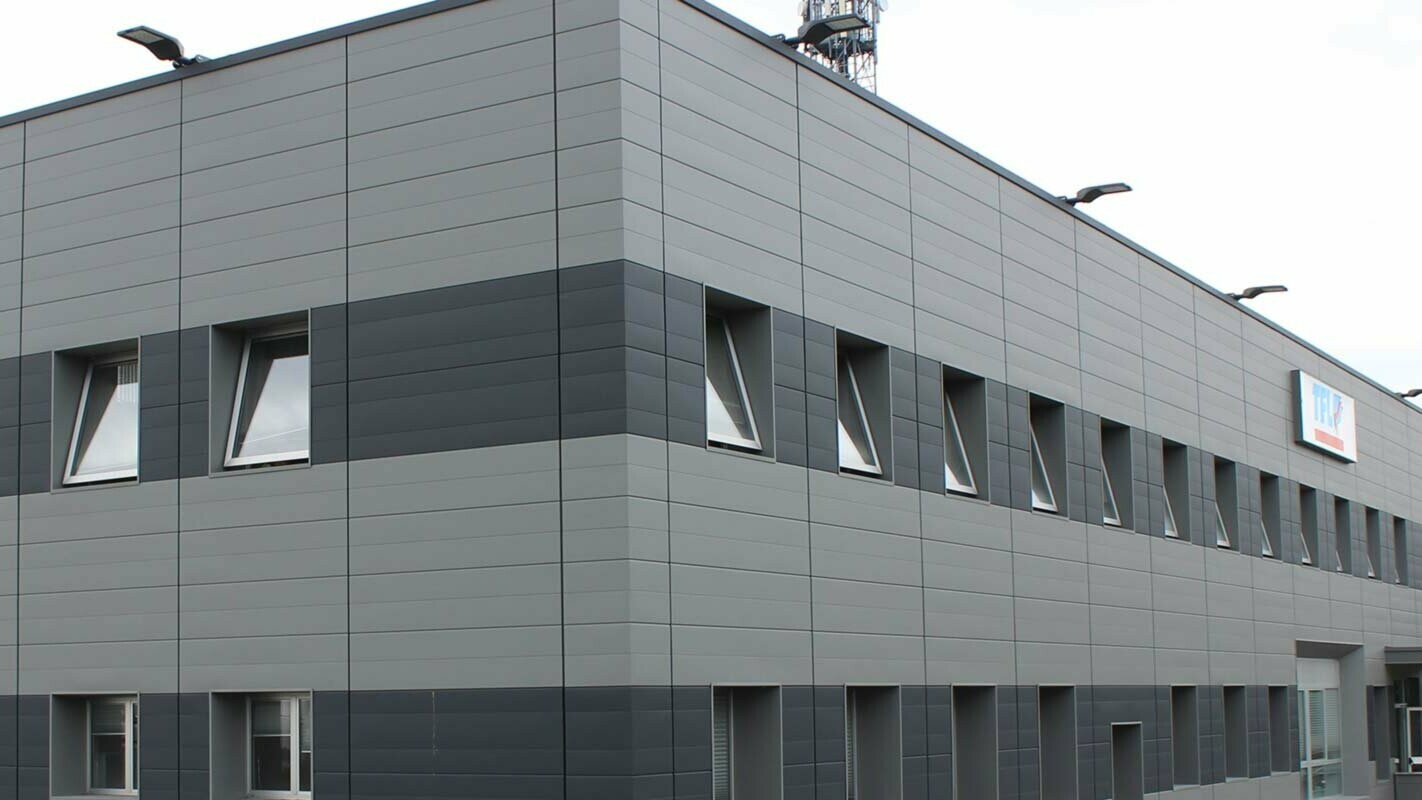 Renovation of a façade of an industrial building with PREFA sidings in several colours