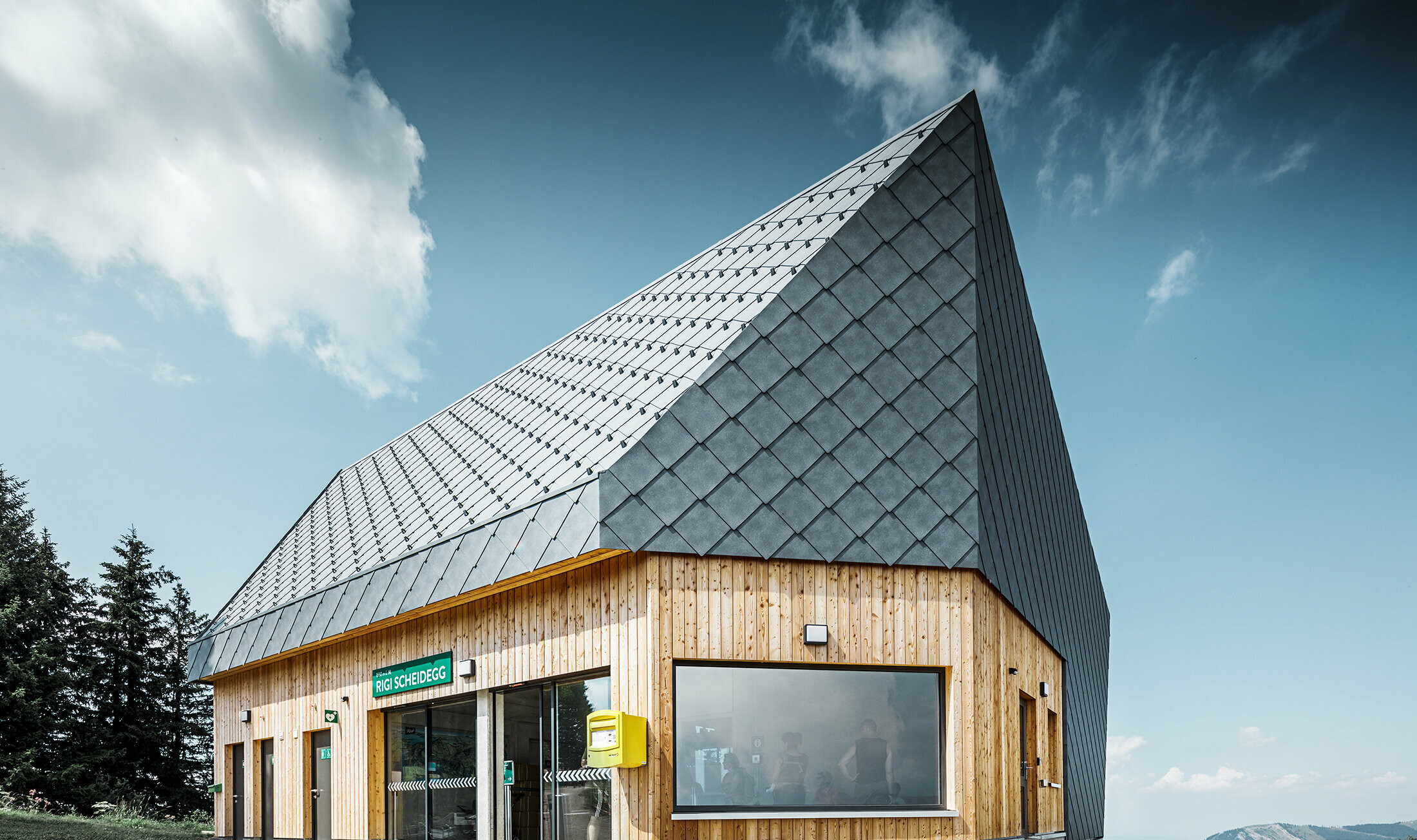 Rigi Railway Scheidegg mountain station in Goldau, Switzerland. The roof and part of the façade were covered with the 44 x 44 rhomboid roof and façade tile in P.10 stone grey.