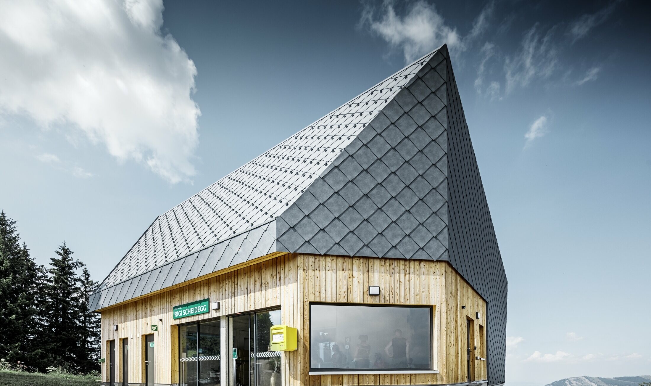 Rigi Railway Scheidegg mountain station in Goldau, Switzerland. The roof and part of the façade were covered with the 44 x 44 rhomboid roof and façade tile in P.10 stone grey.