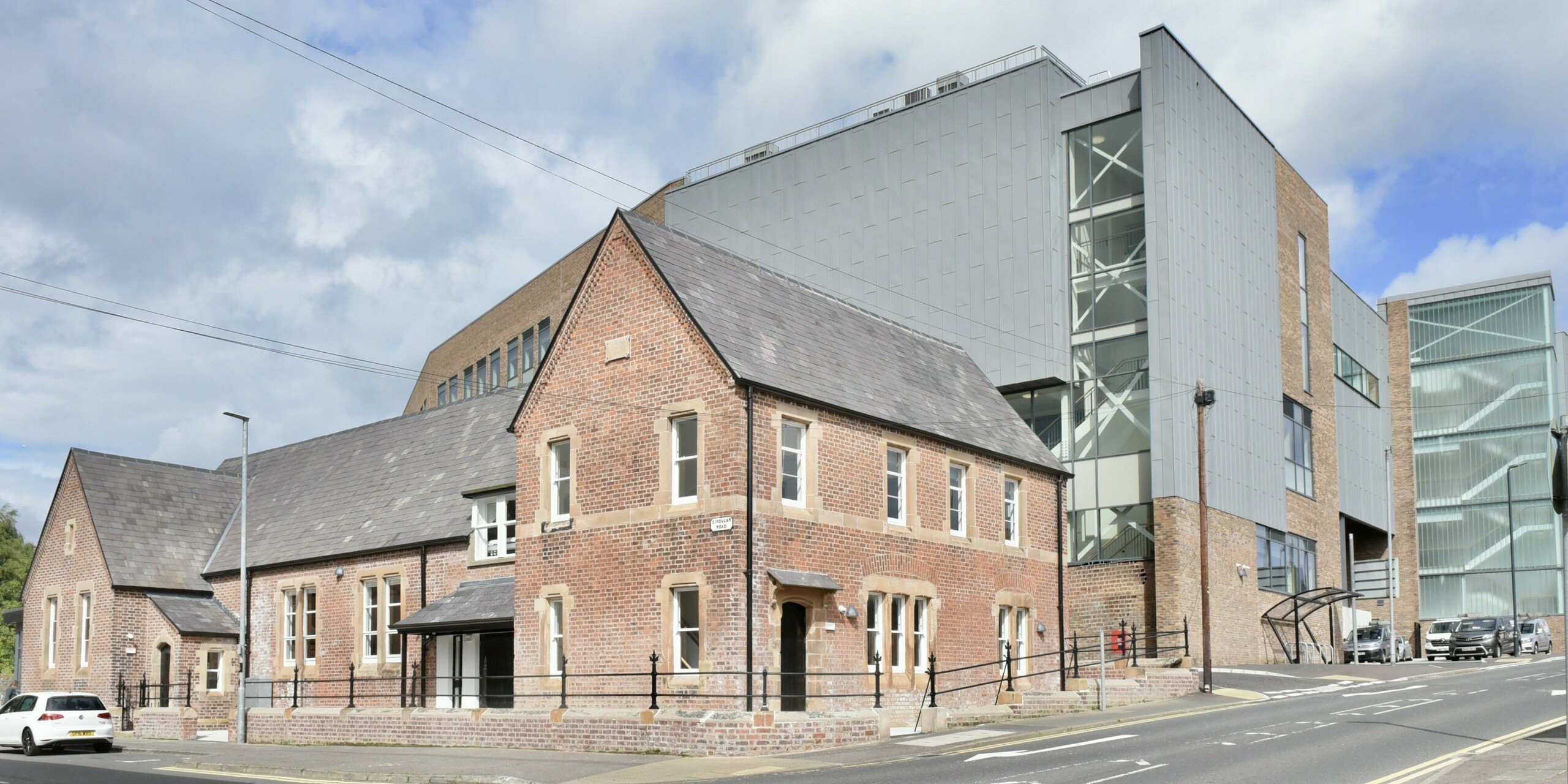 Street view of the Regional College North. The combination of PREFALZ aluminium in patina grey and classic tiles creates a harmonious interplay of modernity and tradition on the building's façade.