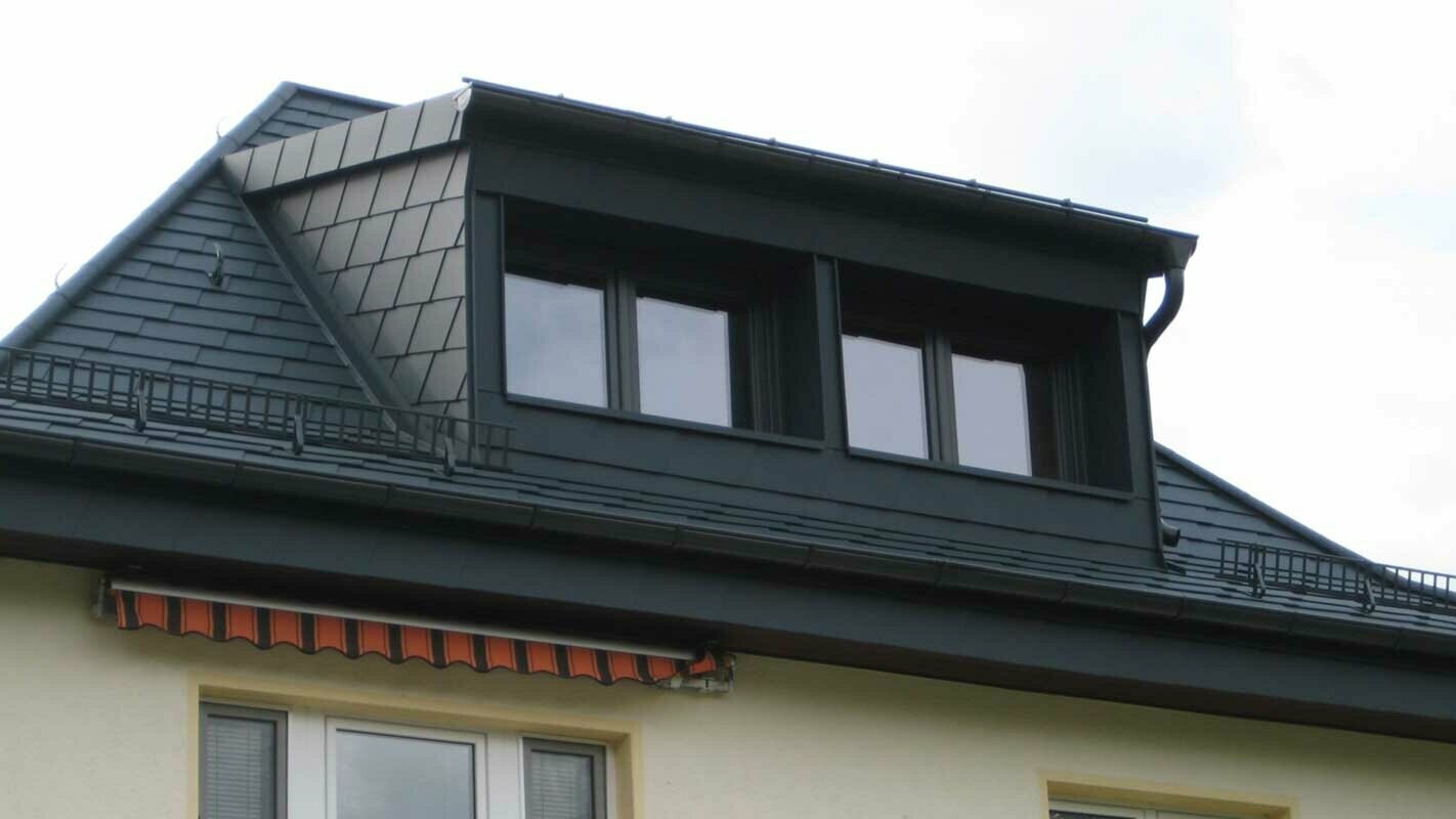 Property with eyebrow dormer renovated with PREFA shingles