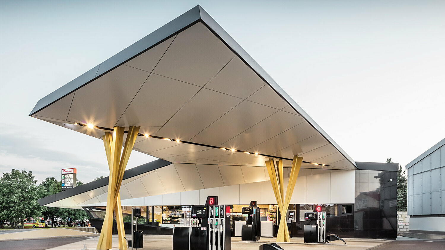 Another side view of the petrol station with the bottom side of the roof and the group of supports in view.