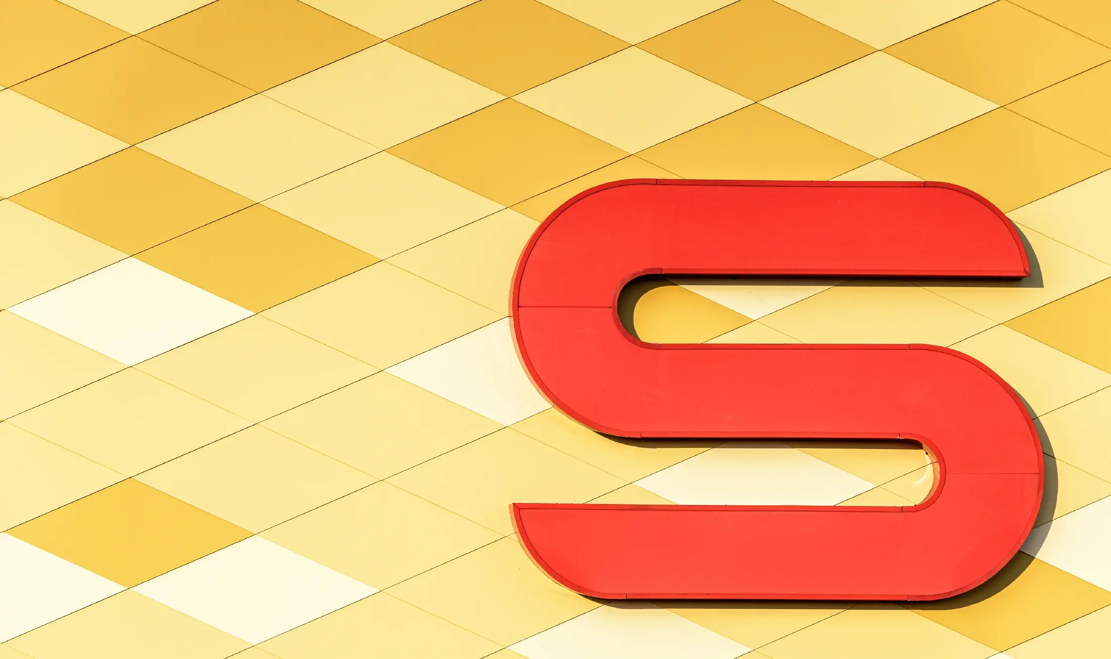Spar branch with an aluminium façade in yellow and orange checks and the Spar logo