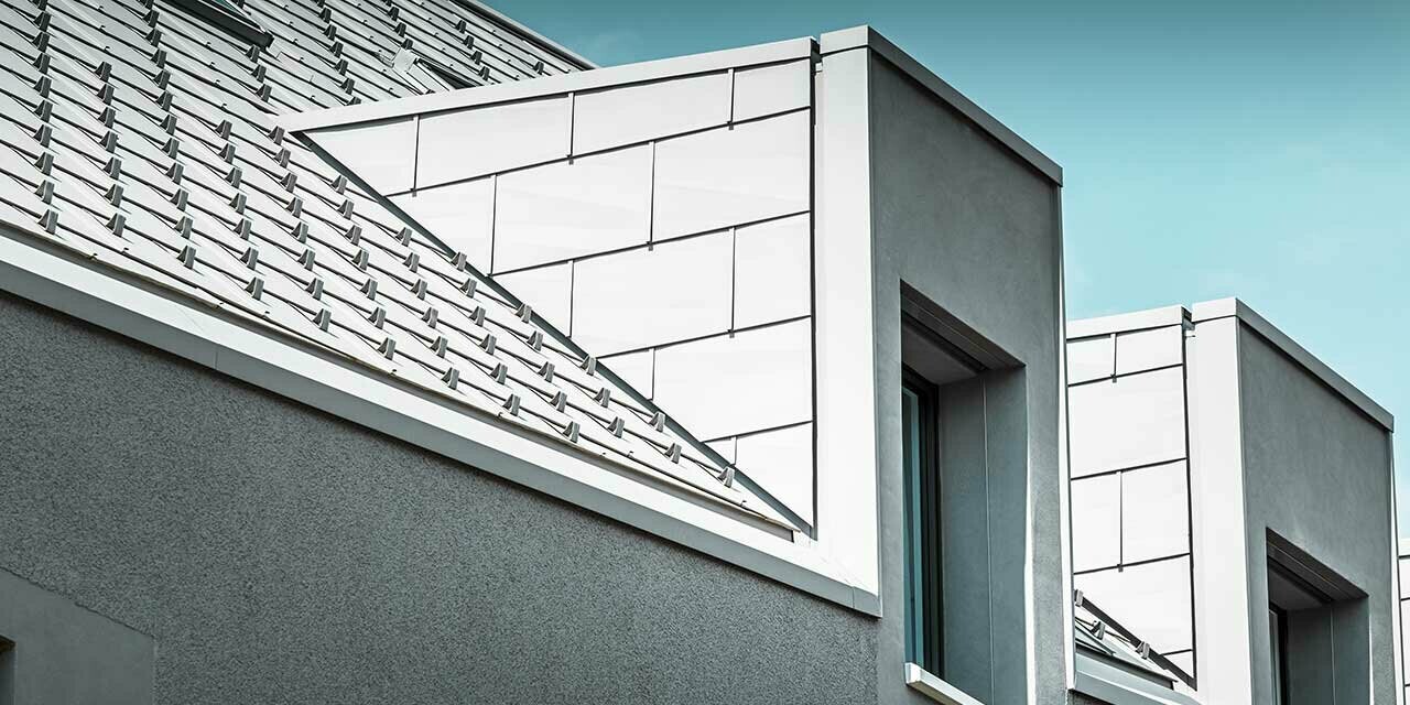 Dormers on an apartment building in Aesch, clad in the PREFA FX.12 in white.