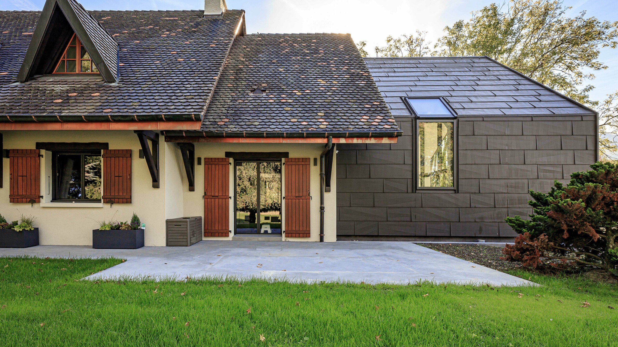 PREFA FX.12 roof and façade panels in P.10 brown, used as a striking design feature on the extension of a detached house in Lully