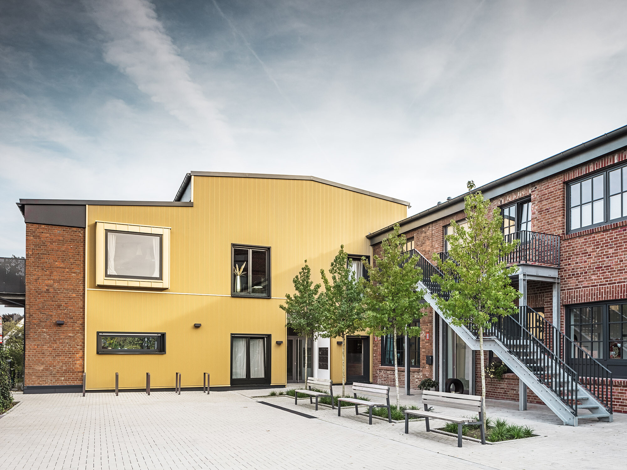 A view of the Kellerhöfe site with the brick and aluminium façades of the former factory building.