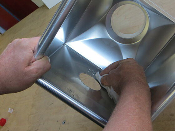 Cleaning the PREFA leader head with PREFA adhesive remover.