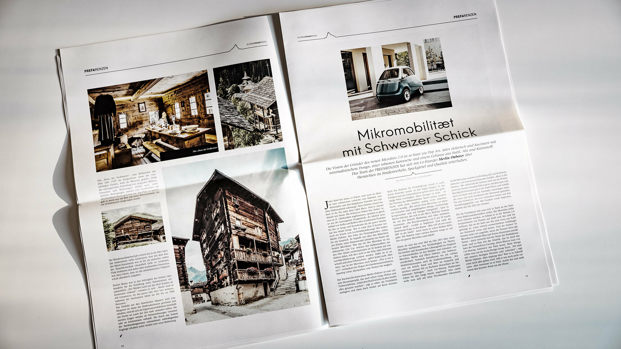 Frontal view of a tilted double page with text and architecture photos.