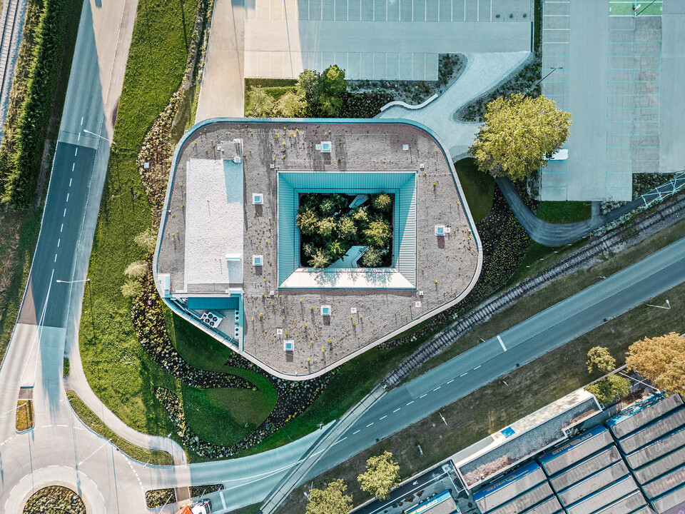 The Walters restaurant in the WALTER GROUP business park from a bird eye's view, with a focus on the forest in the atrium as well as the surrounding streets. 