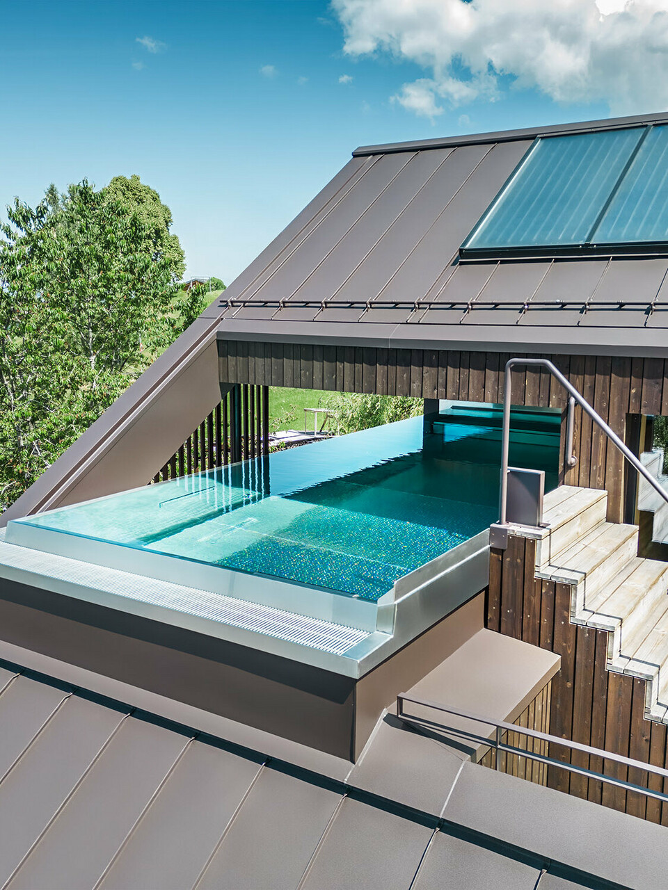 Section of the pool embedded in the sloping roof of the multi-family house Matino in Übersaxen.