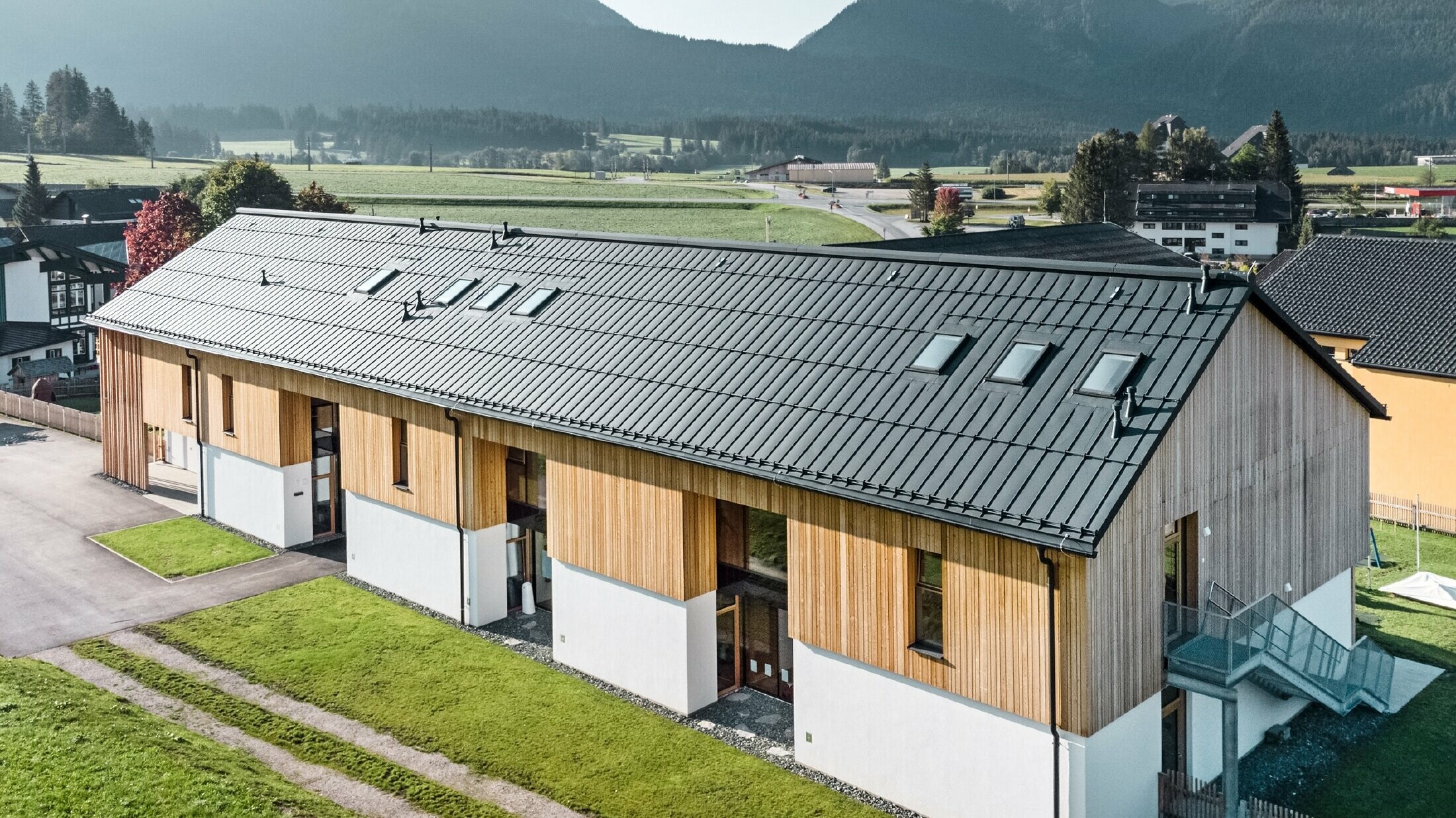 Herb kindergarten in Bad Mitterndorf with large PREFALZ roof in P.10 anthracite and wooden façade