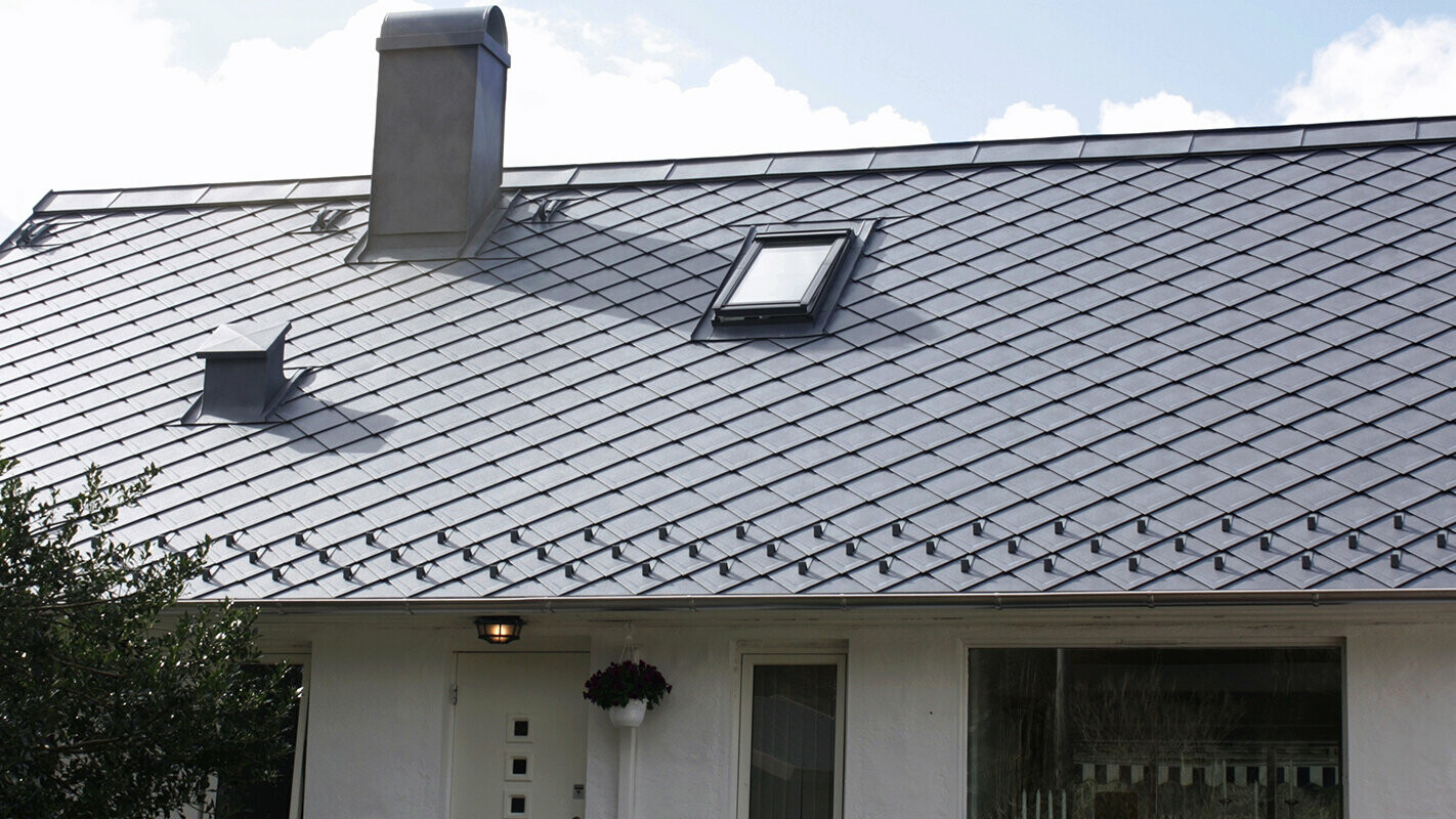 Before roof renovation with PREFA rhomboid roof tiles including chimney