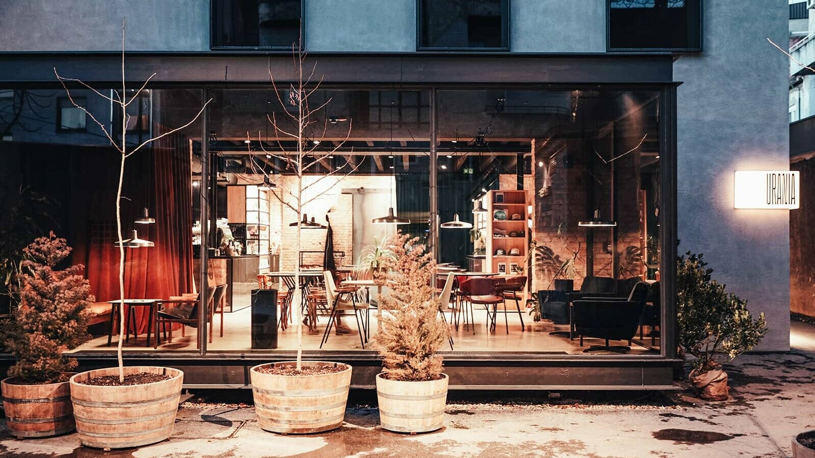 You can look inside through a large glass front. You can see a small café with seating. 