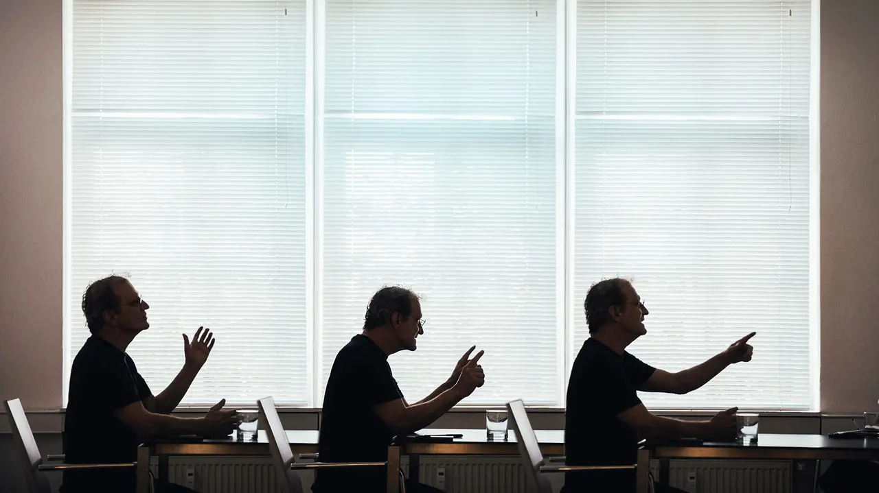 Three profile views of the architect Anton Mariacher looking to the right with different gestures.
