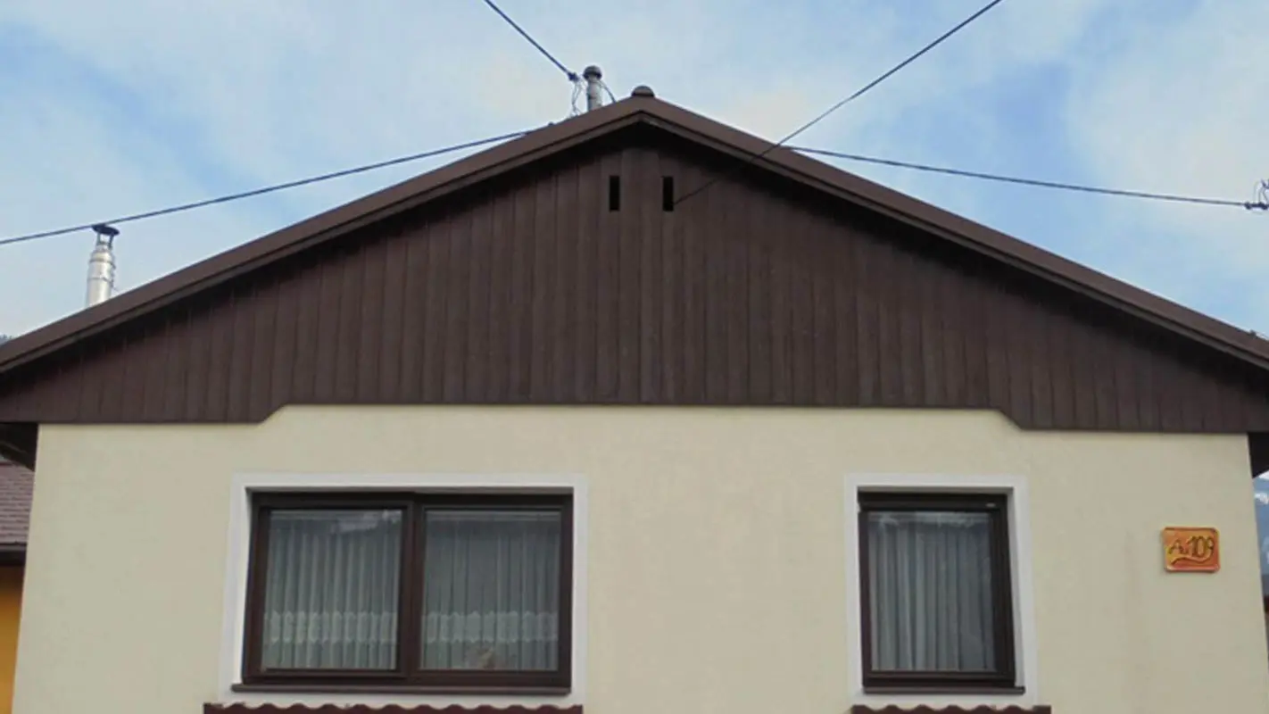 Before renovation of gable façade with PREFA sidings, yellow rendered façade and weathered wood