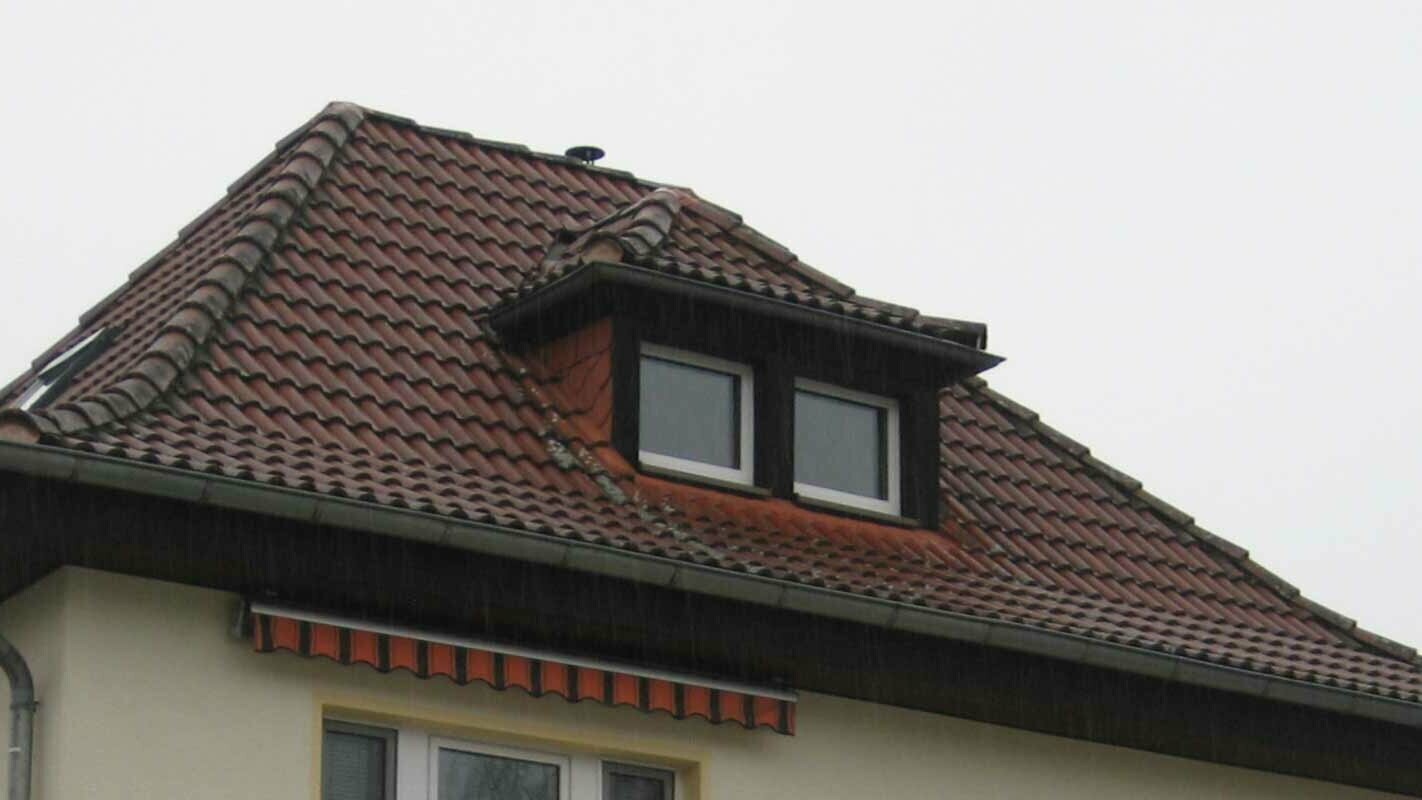 Hip roof with eyebrow dormer before renovation with PREFA shingles
