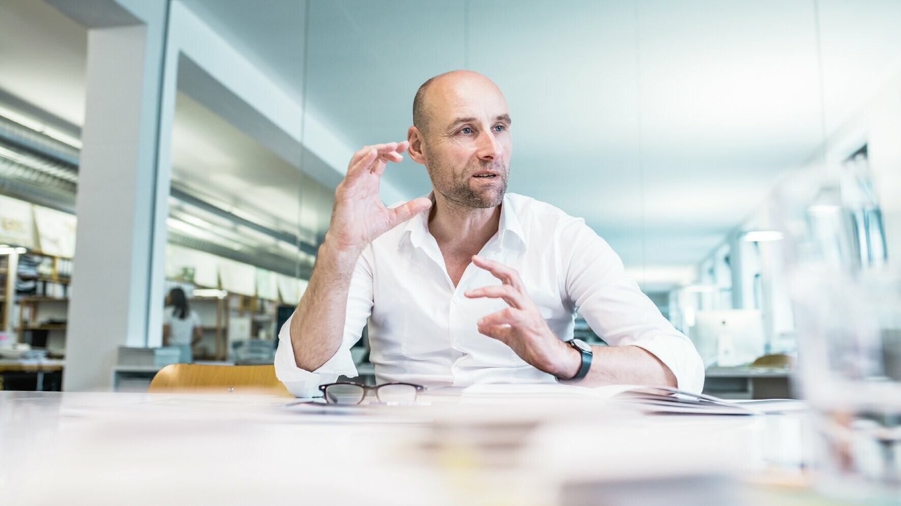 A picture of architect Moritz Auer, sitting by his desk