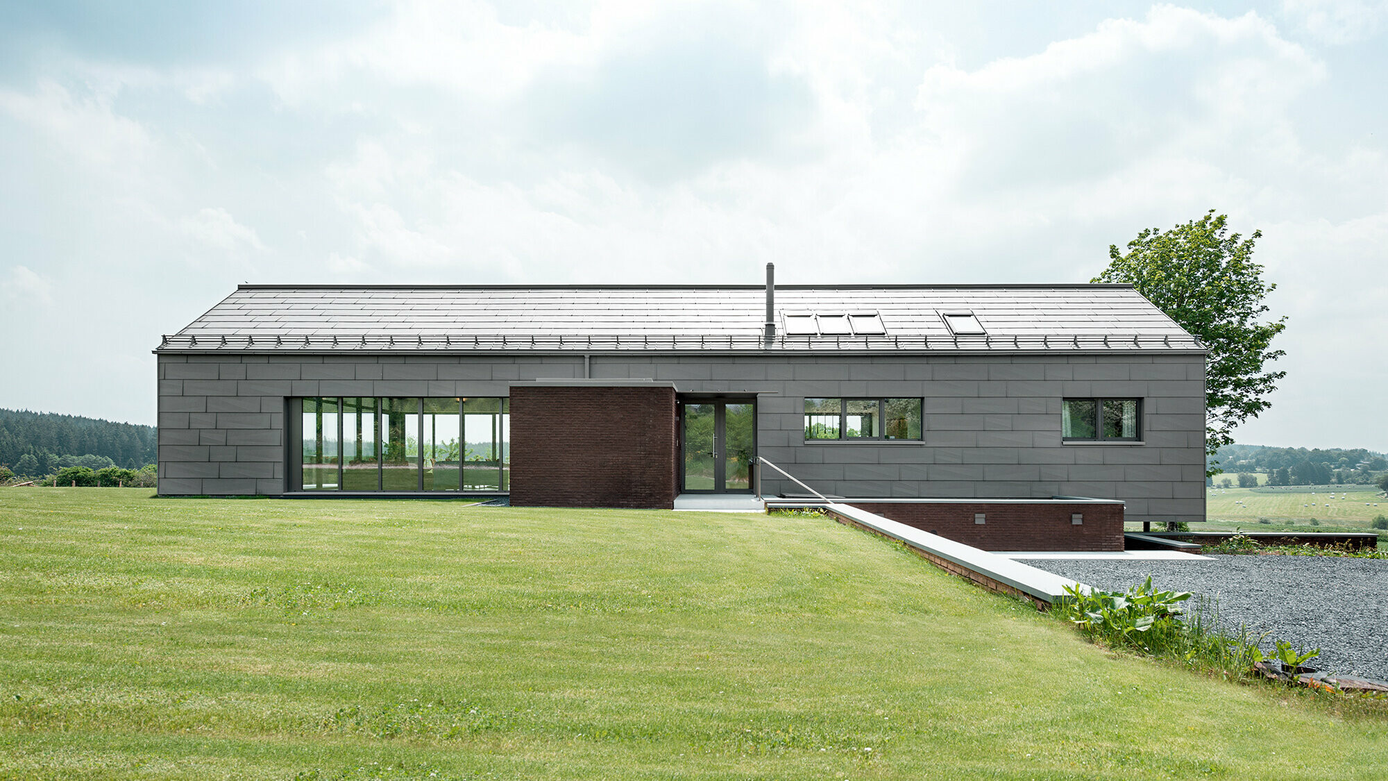View of the building from the north side, you can see through it in certain sections due to the glazing.