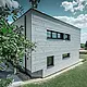 Side view of a modern detached house showing the Siding.X façade.