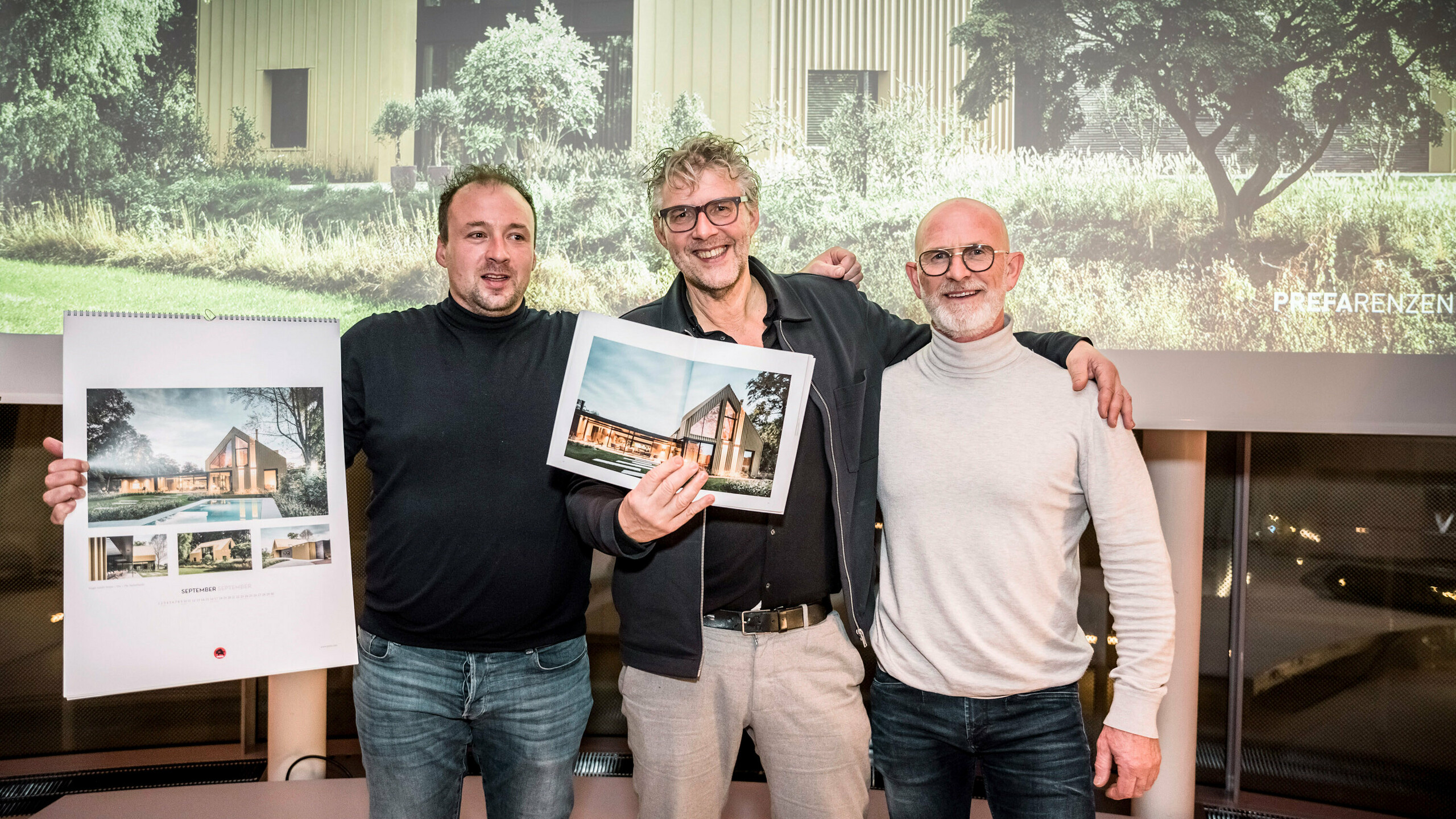 Installer Johan Duinkerke holding the calendar, architect Kees Marcelis holding the book, Henk Smienk.