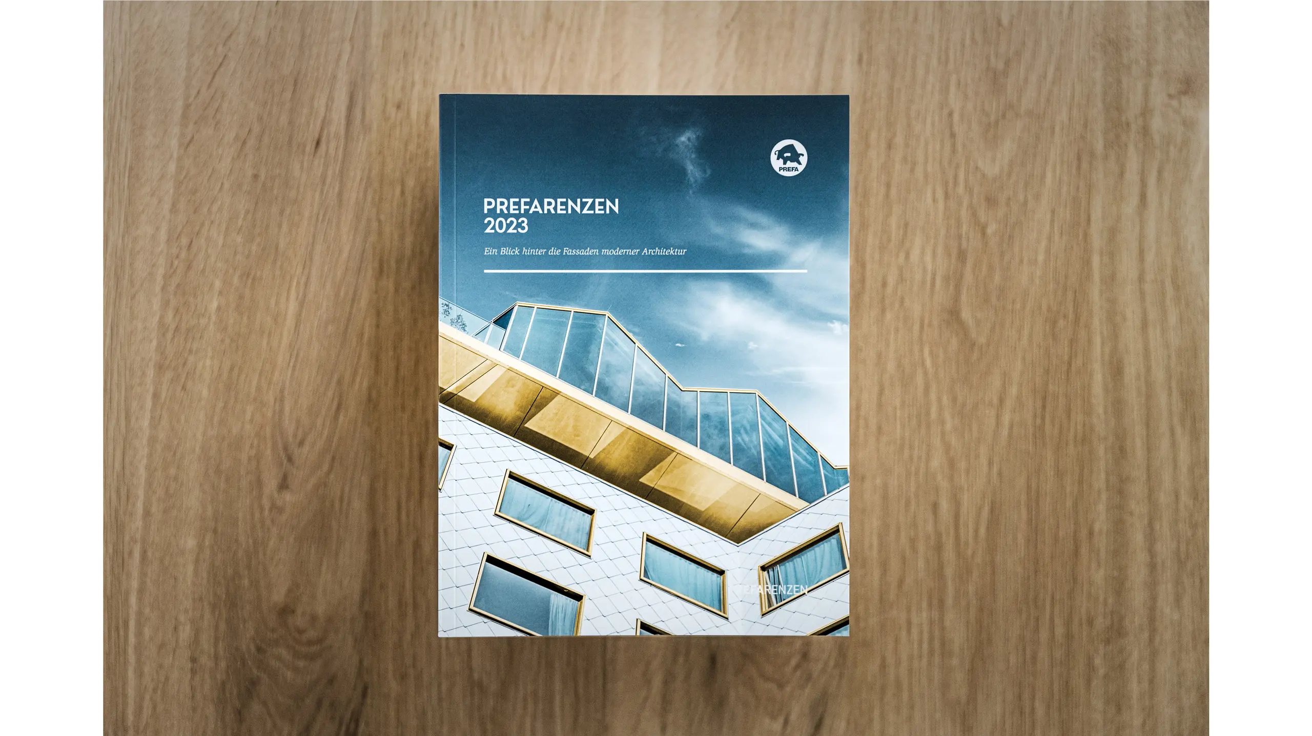 The book cover from a bird's eye view, the book is placed on a stack of several issues.