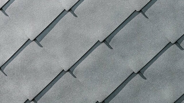 Detailed image of the PREFA aluminium rhomboid façade tiles 44 × 44 in P.10 stone grey
