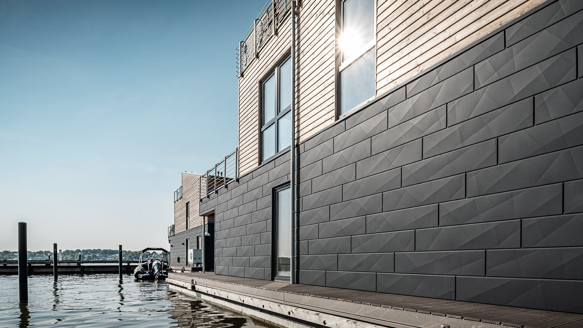 The irregularly structured siding.X façade of one of the water houses up close.