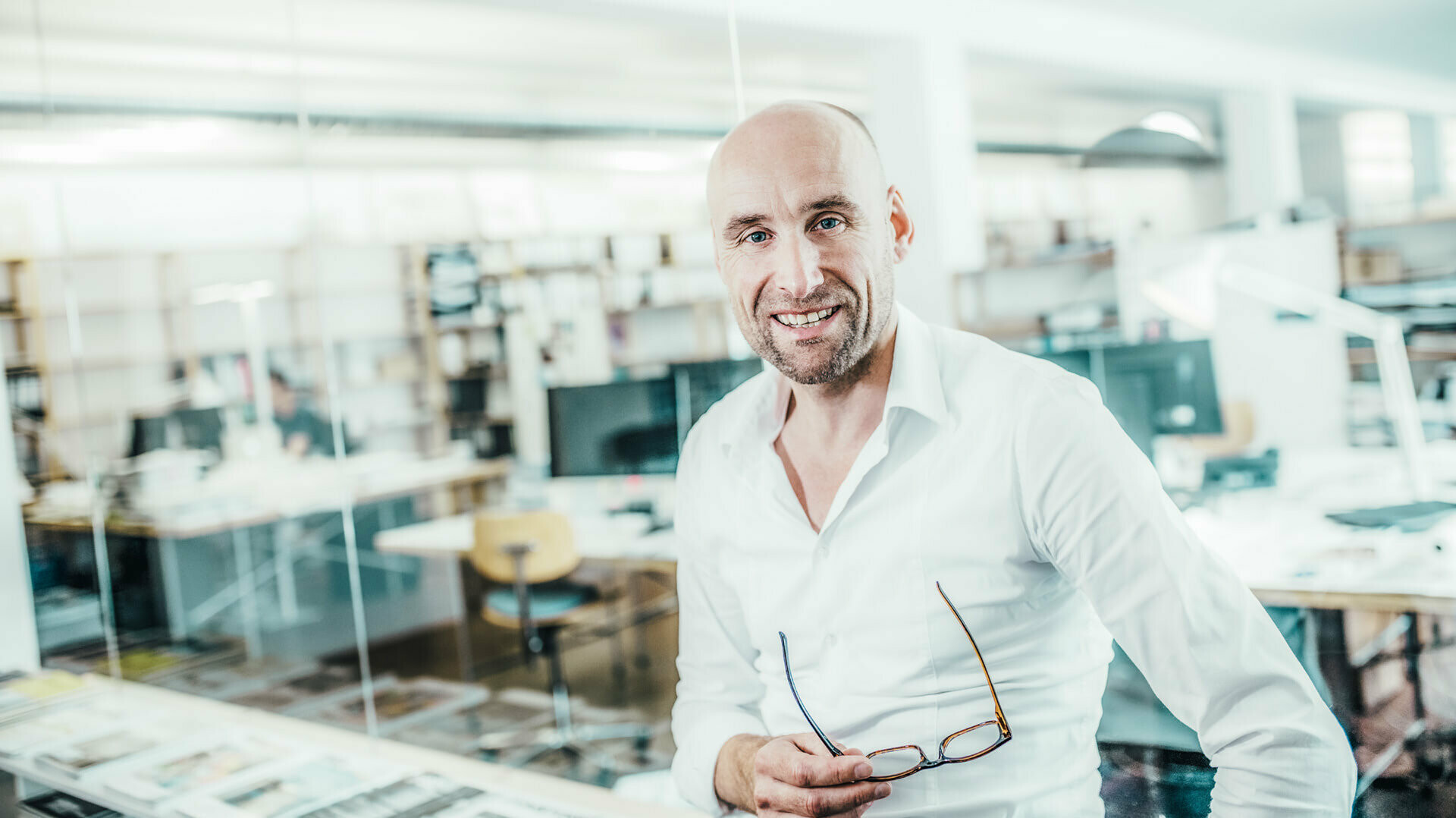 A picture of architect Moritz Auer, holding his glasses