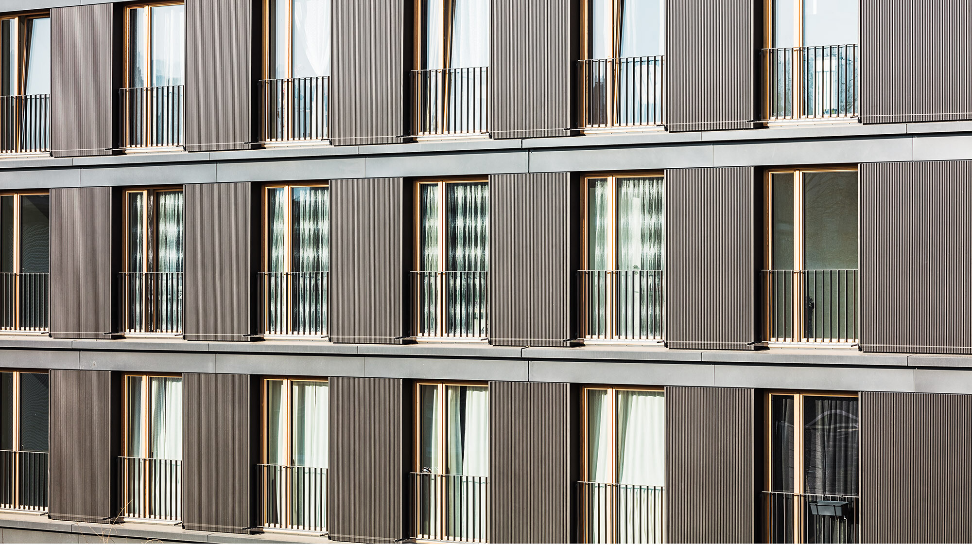 The building's profiled aluminium façade and windows from up close.