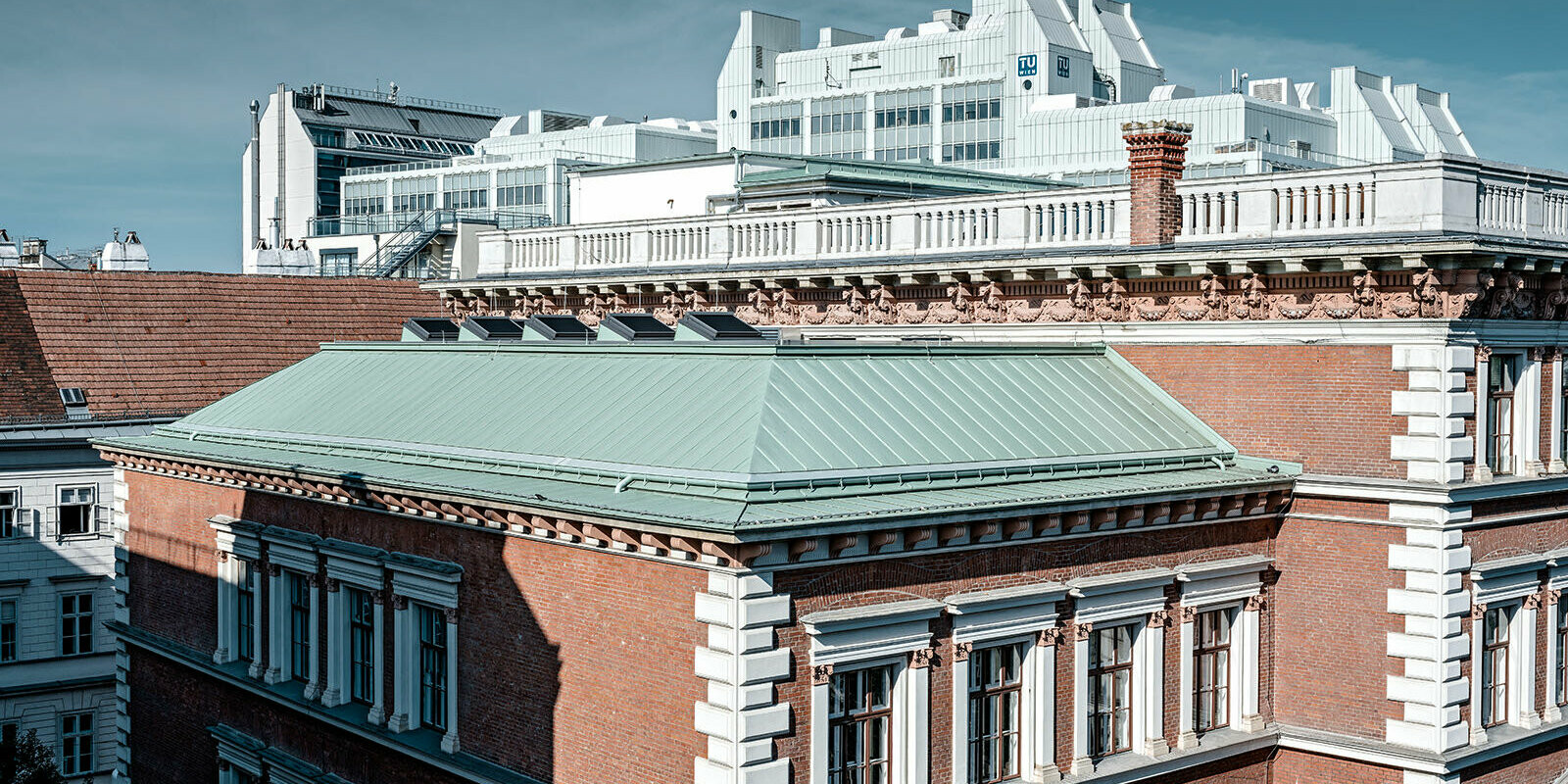 A picture of the protestant elementarty school at Karlsplatz, Vienna. The roof was clad with Prefalz in P.10 patina green. In the background the technical University of Vienna can be seen.