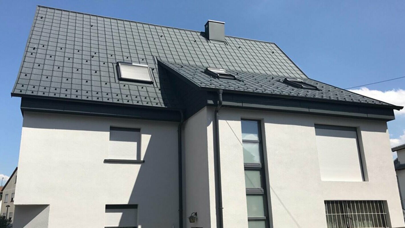 Gable roof renovation with PREFA roof tiles, white façade