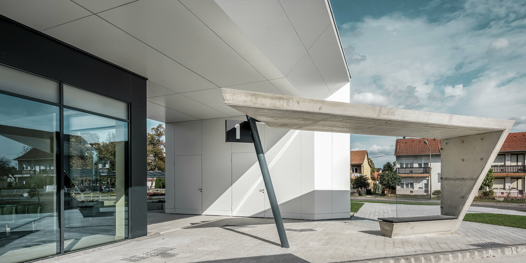 The new railway station in Lenti. The picture shows the bus stop number one. PREFABONd aluminium composite panels in the colour P.10 anthracite and pure white was used on the showed façade.