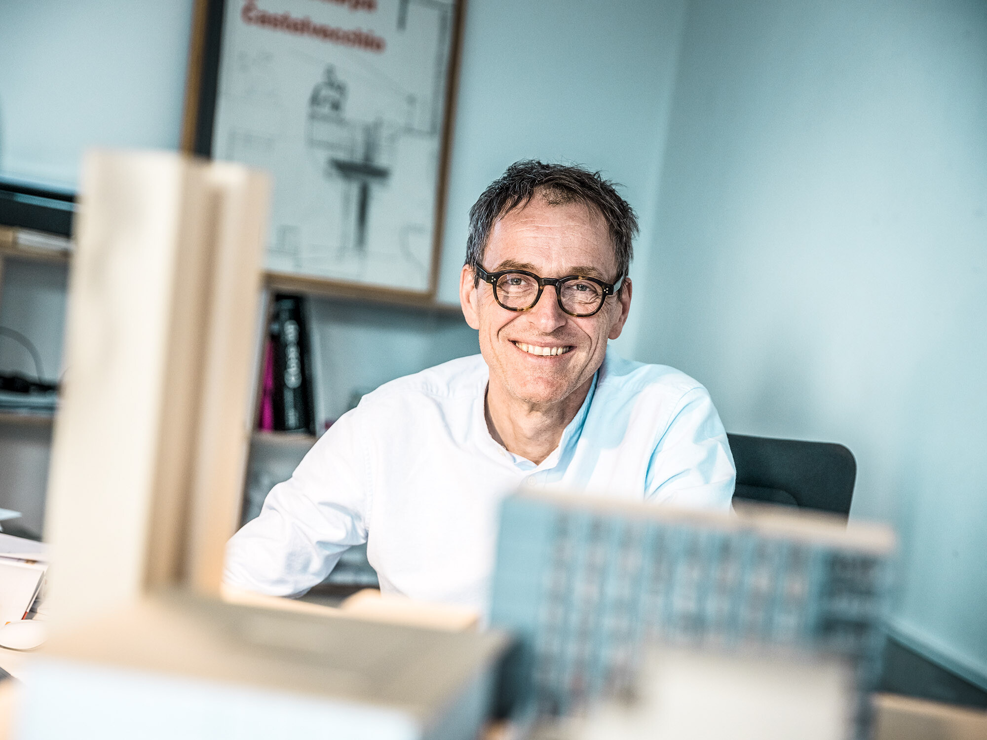 Portrait of the lead architect Jochen Weissenrieder, smiling, at his office.