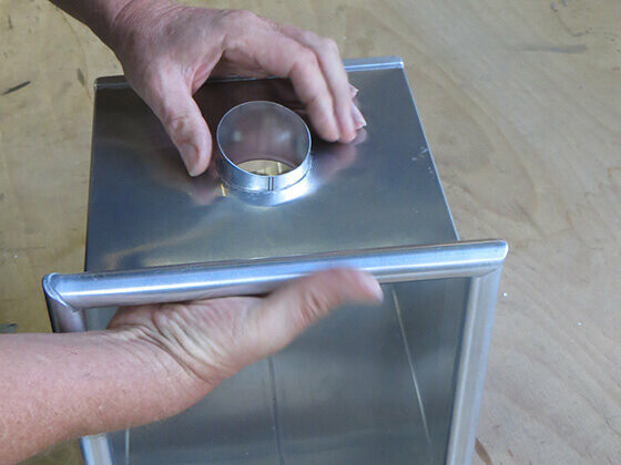 Push the outlet with bonding flange through the PREFA leader head from the inside (the longest side of the PREFA outlet should be at the bottom).