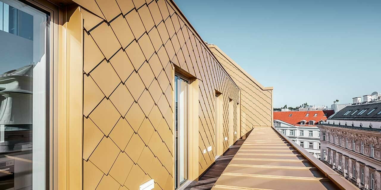 Brandstätte loft extension in Vienna clad in the 29 x 29 rhomboid façade tile in pearl gold.