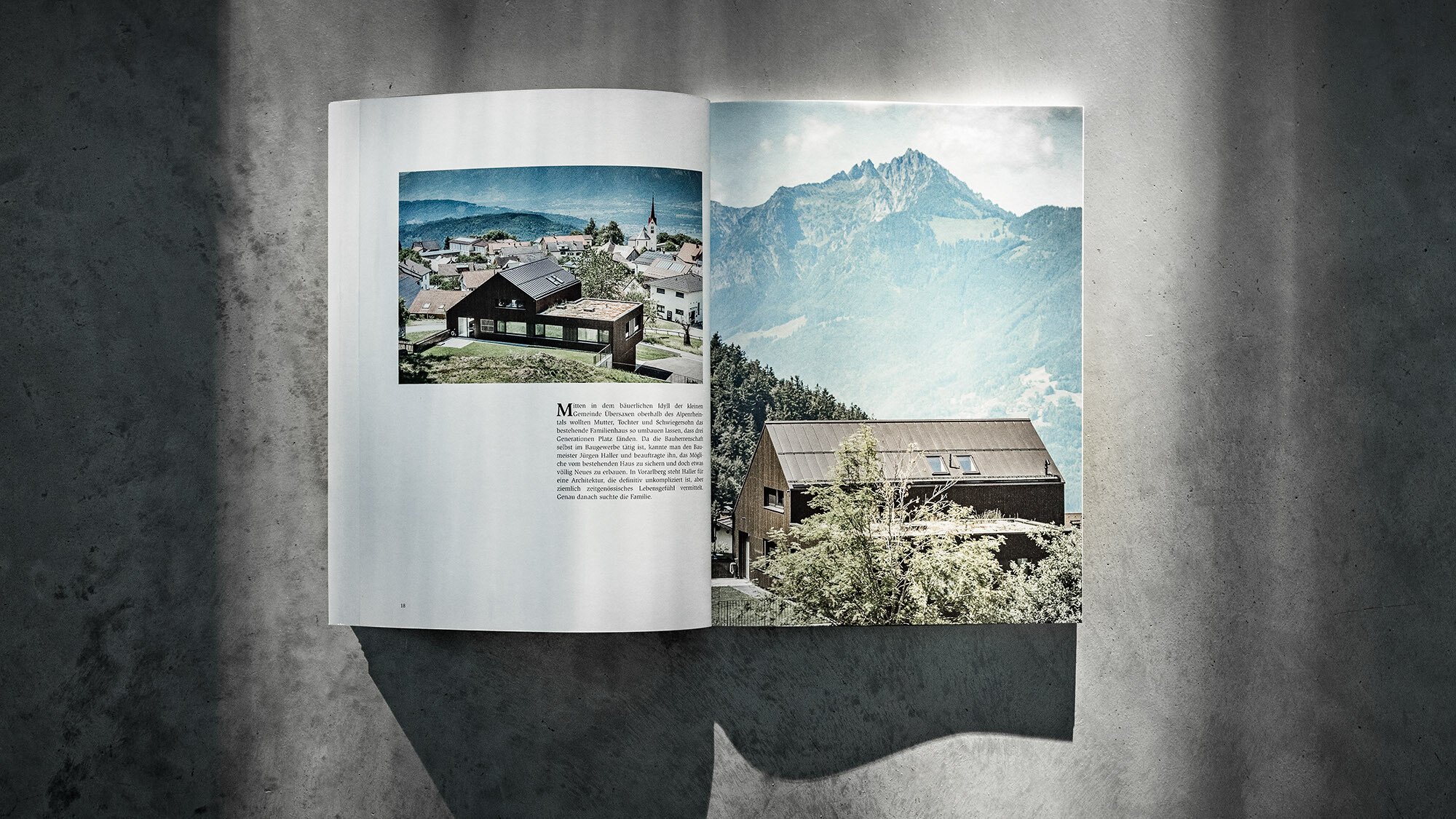 The open PREFARENZEN book 2024 with an article on the multi-family house Matino by Jürgen Haller before a grey background.