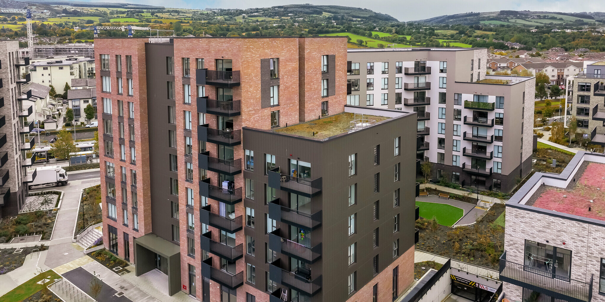 Aerial view of the Citywest Apartments in Dublin. The vertically laid PREFA sidings in P.10 Brown on approx. 700 m² complement the traditional brick façade. Modern architecture and a durable aluminium façade combine attractive design with weather resistance.