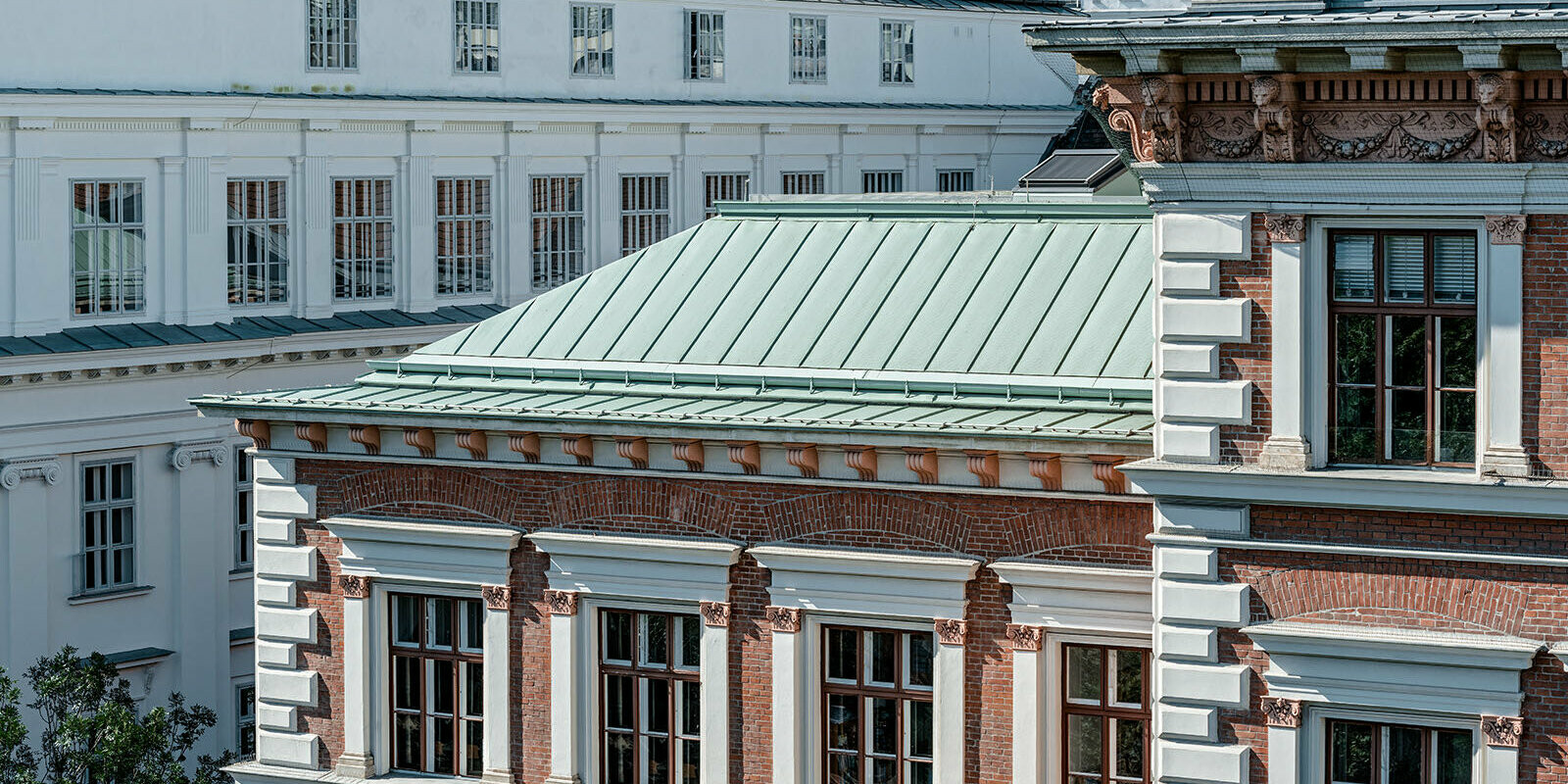 A picture of the protestant elementarty school at Karlsplatz, Vienna. The roof was clad with Prefalz in P.10 patina green, the façade is made of bricks.
