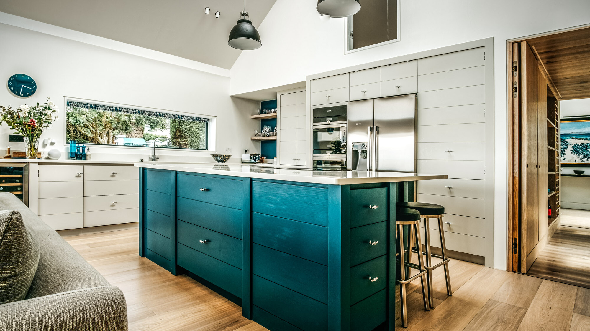 A peek into the spacious kitchen-living room designed in natural tones.