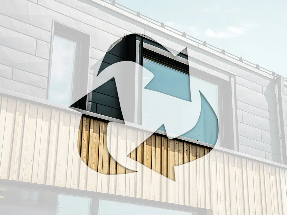 Photo shows the recycling symbol on a house façade with PREFA aluminium elements and wood panels.